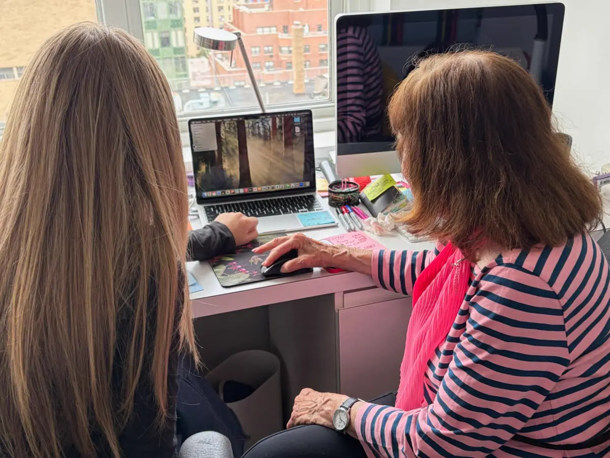 Allie guiding a resident through using a laptop during a Tech Talk session
